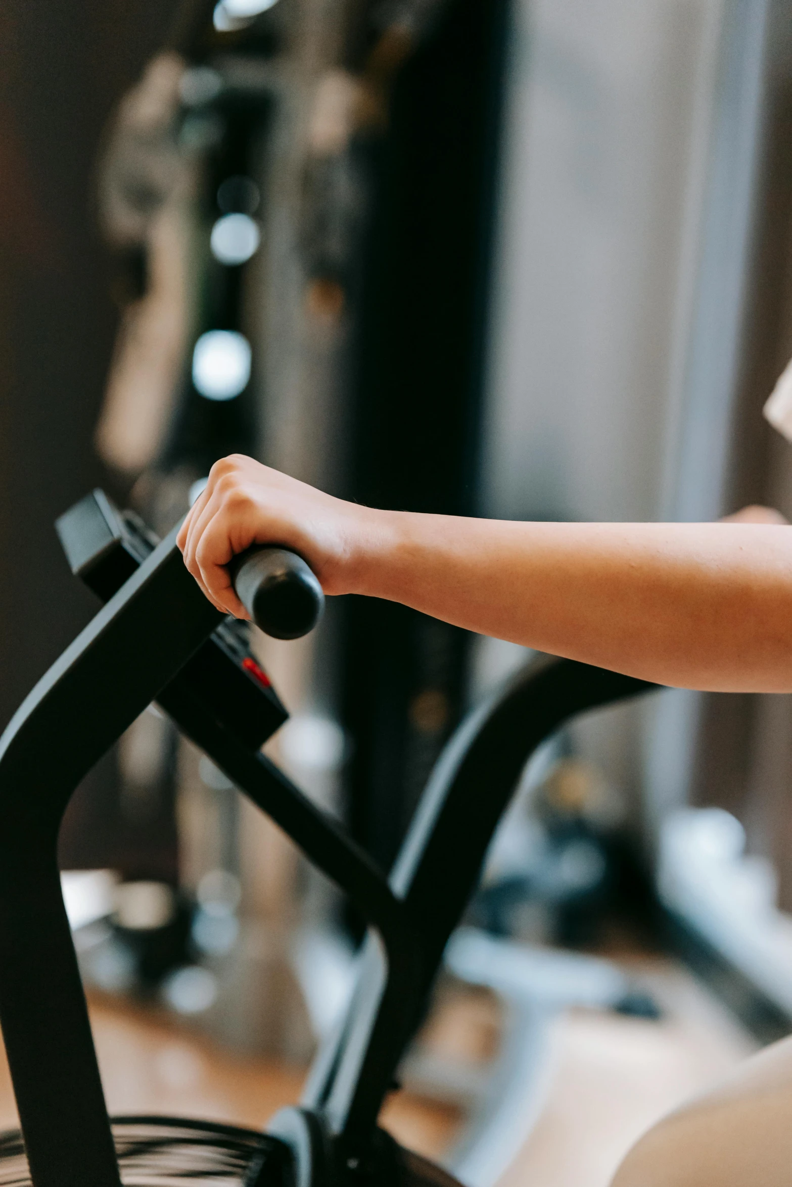 a woman using a stationary bike in a gym, pexels contest winner, closeup of arms, profile image, thumbnail, digital image