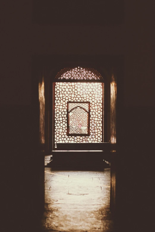 a light shines through a window in a building, unsplash contest winner, arabesque, in front of a carved screen, faded and dusty, instagram picture, opening door