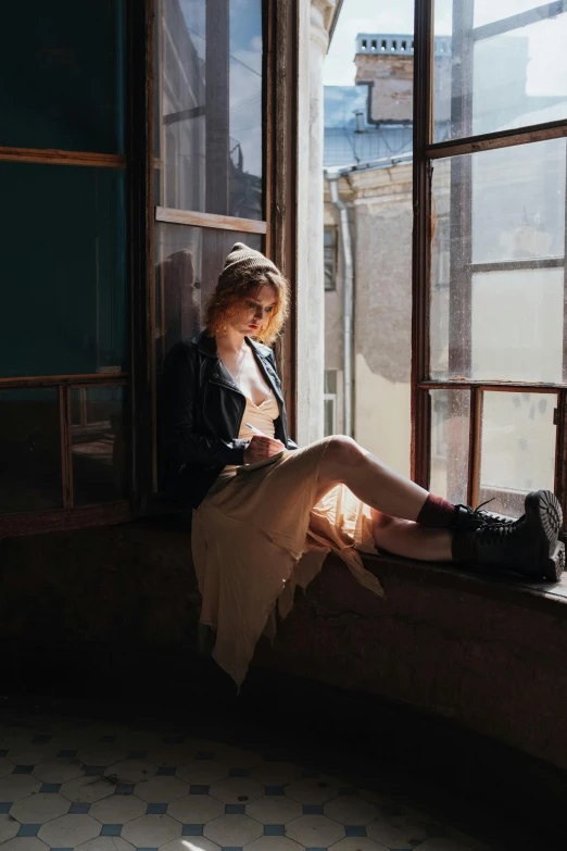 a woman sitting on a window sill reading a book, unsplash contest winner, wearing jacket and skirt, sophia lillis, window lighting, sydney sweeney