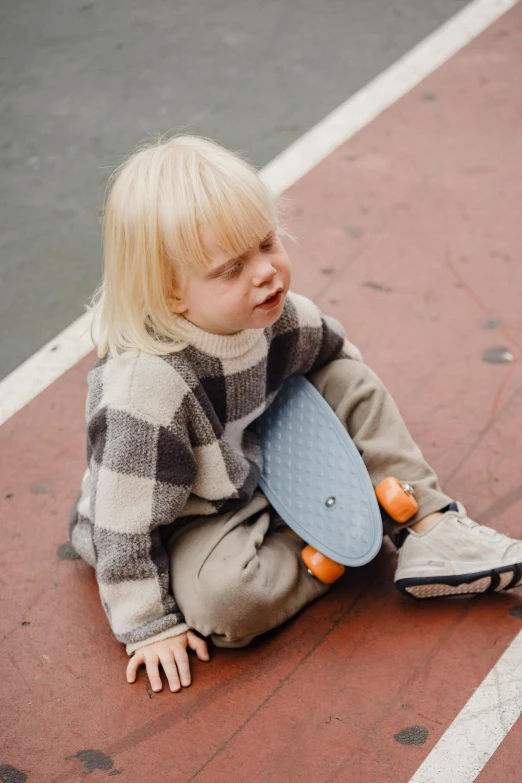 a little girl sitting on the ground with a skateboard, pexels contest winner, boy with neutral face, bumpy, thumbnail, small blond goatee