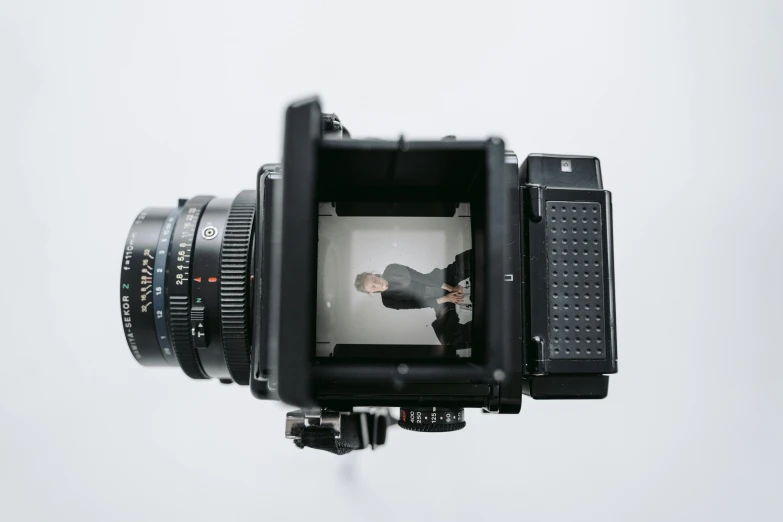 a close up of a camera on a tripod, a polaroid photo, by Matthias Weischer, hyperrealism, full body 8k, 4k symmetrical portrait, hasselblad medium format, portrait of a small