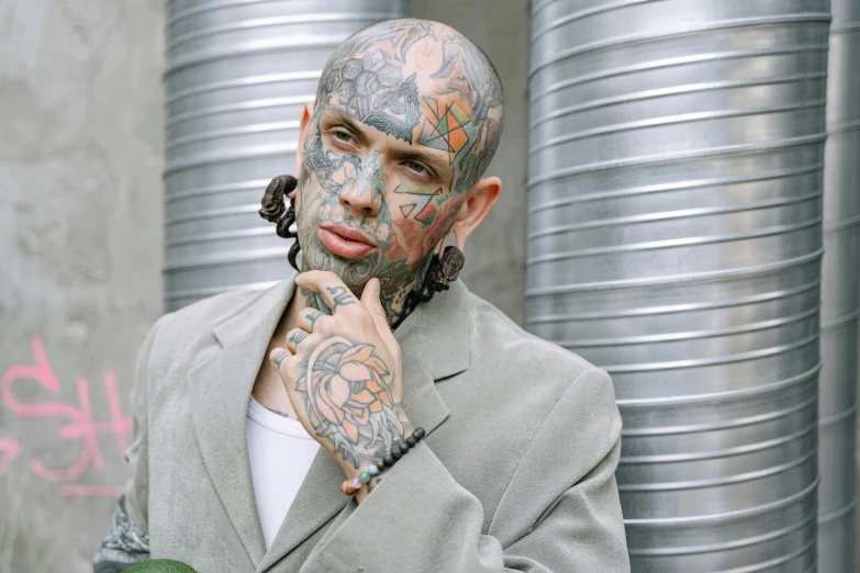 a man with a lot of tattoos on his face, inspired by Seb McKinnon, trending on pexels, hyperrealism, gangster, 90s photo, scaly, lean man with light tan skin