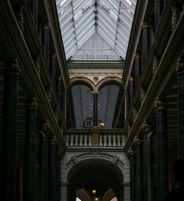 a couple of people that are standing in a building, inspired by Thomas Struth, pexels contest winner, light and space, intricate detailed roof, you can see all the passageways, wunderkammer, stone and glass and gold