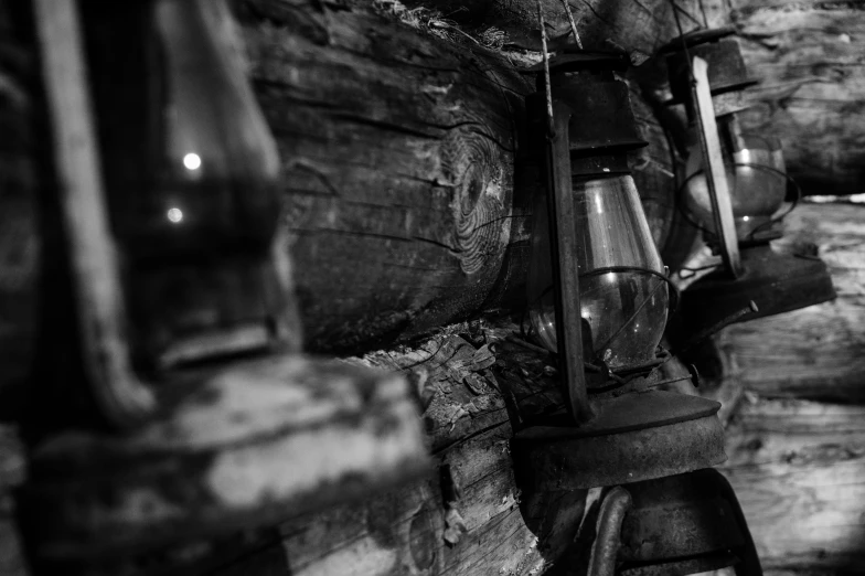 a black and white photo of a log cabin, a portrait, pexels contest winner, process art, gas lamps, detail, cellar, treasures