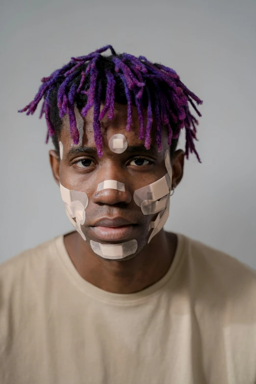 a man with tape all over his face, by artist, trending on pexels, afrofuturism, purple mullet, square face, face scars, portrait of young man
