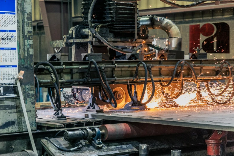 a man that is standing in front of a machine, pexels contest winner, steel plating, facing sideways, cast iron material, avatar image