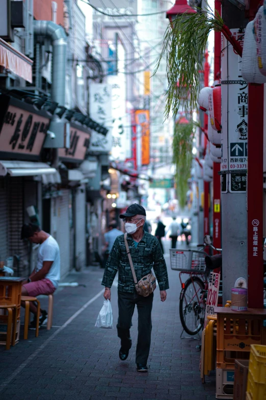 a man wearing a face mask walking down a street, by Meredith Dillman, pexels contest winner, ukiyo-e, deserted shinjuku junk town, late summer evening, square, ethnicity : japanese