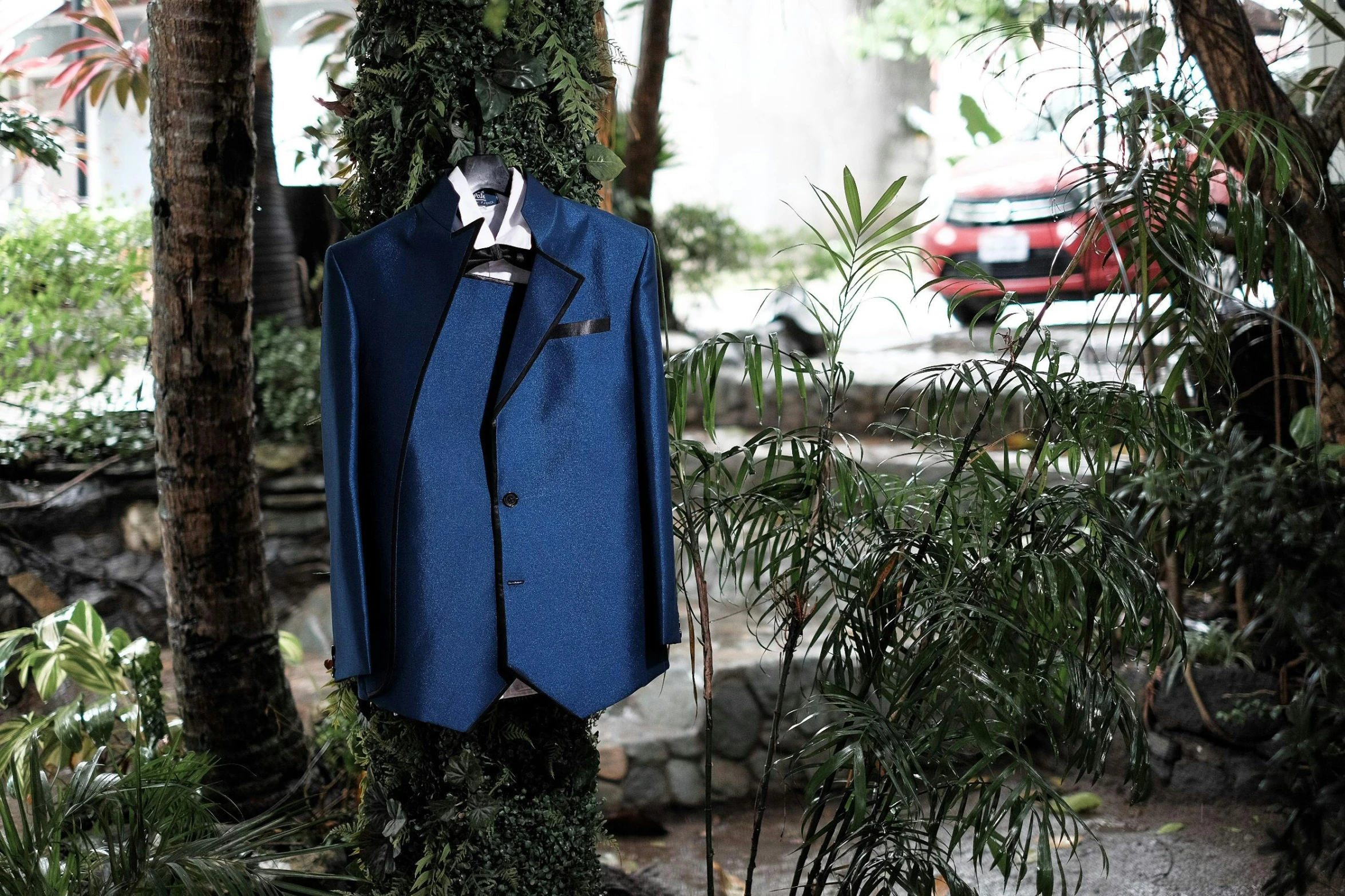 a blue suit sitting on top of a tree, garments, in tokio, lush surroundings, displayed