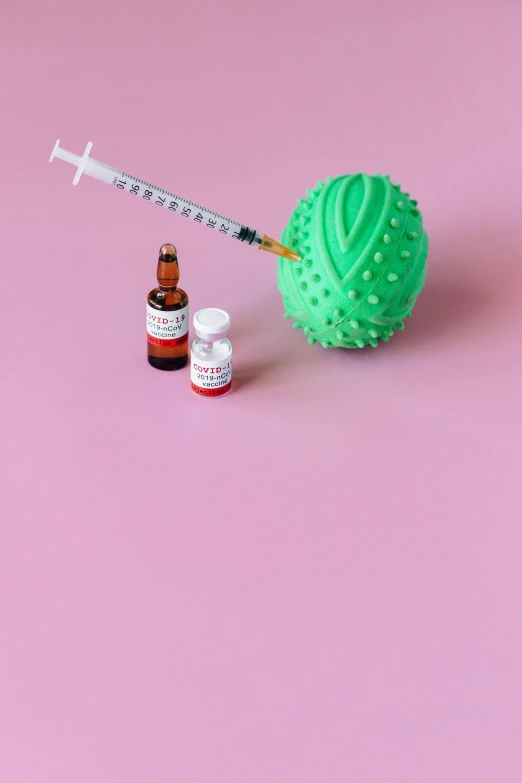 a needle and a bottle of medicine on a pink background, inspired by Damien Hirst, unsplash, green sea urchin, coronavirus as a stuffed toy, insanely inflated hips, cannabis