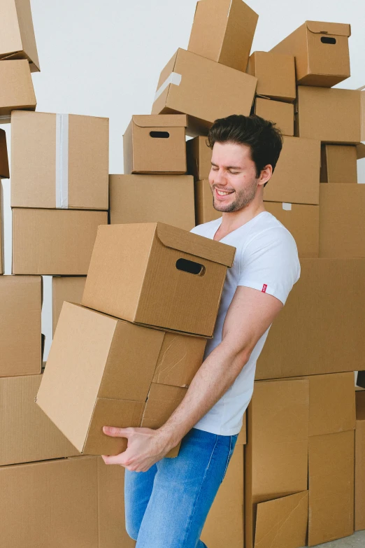 a man carrying a stack of cardboard boxes, by Niko Henrichon, shutterstock, renaissance, mid-shot of a hunky, australian, transgender, opening