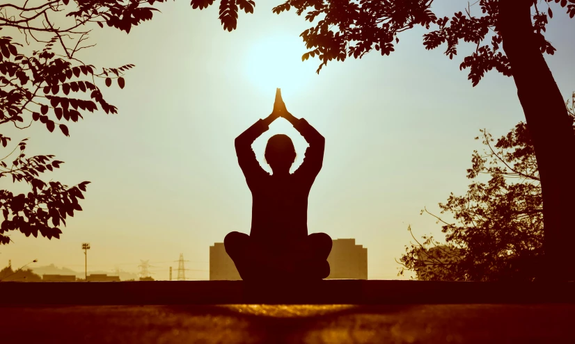 a silhouette of a person doing a yoga pose, pexels contest winner, bright sunny day, avatar image, brown, sitting