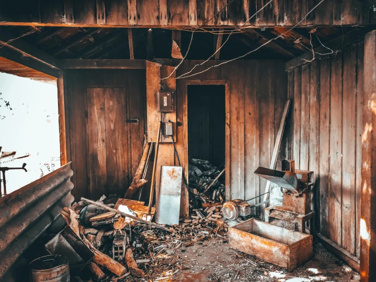 a room filled with lots of wood next to a window, pexels contest winner, auto-destructive art, rust and dust and fire and dirt, lachlan bailey, tools and junk on the ground, old cabin