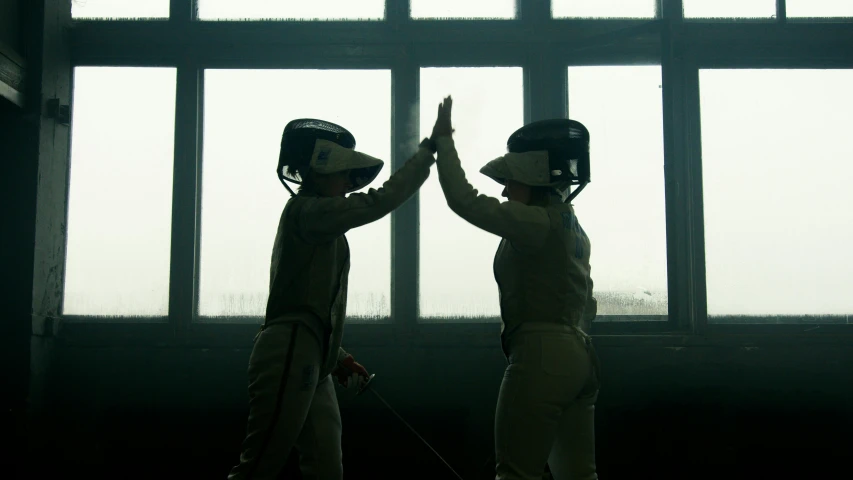 two fencers giving each other a high five, a portrait, pexels contest winner, denis villeneuve movie still, white helmet, women, profile image