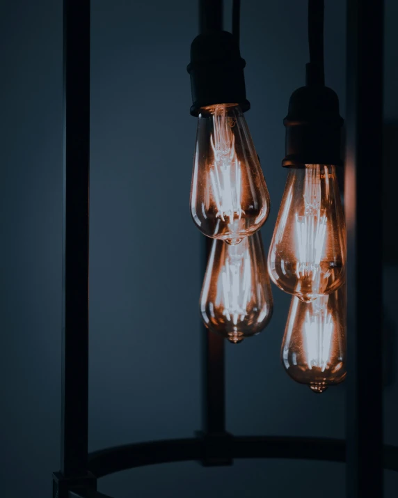 a group of light bulbs hanging from a ceiling, inspired by Elsa Bleda, trending on pexels, standing in a dimly lit room, bisexual lighting, good lighted photo