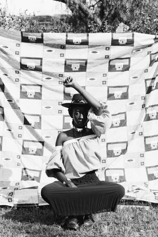 a black and white photo of a woman holding a quilt, unsplash, black arts movement, ( pirate with a bandanna ), 1 9 7 3 photo from life magazine, tyler the creator, square