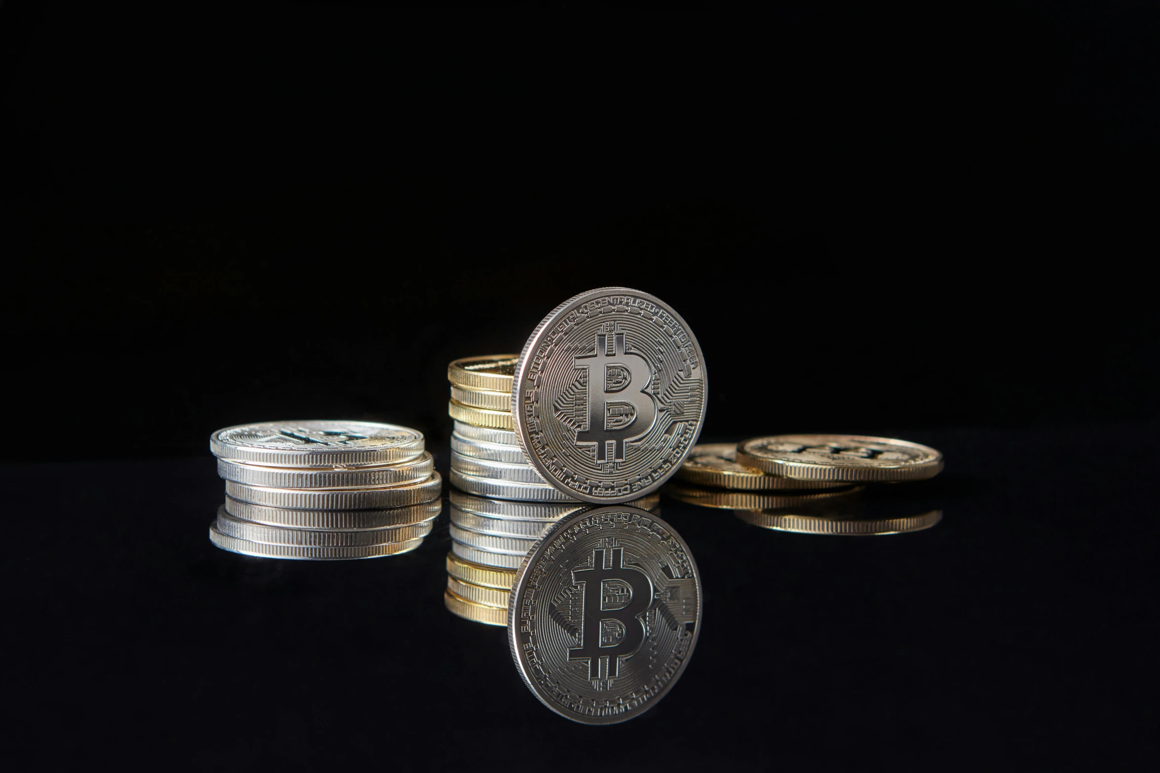 a stack of coins sitting on top of each other, in front of a black background, bitcoin, product display photograph, mirroring