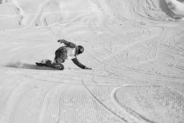 a man riding a snowboard down a snow covered slope, a black and white photo, by Emma Andijewska, crawling on the ground, 'action lines '!!!, sand, corduroy