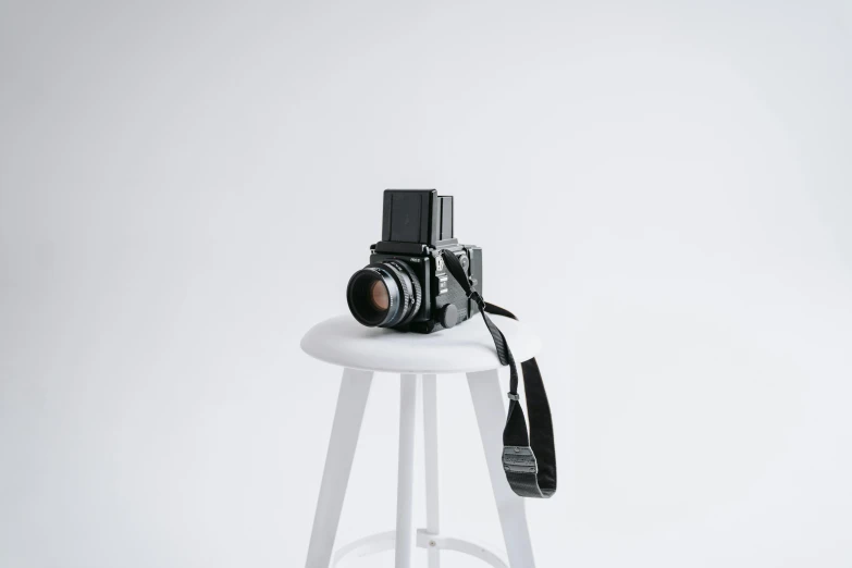a camera sitting on top of a white stool, by Will Ellis, medium format, picture, various posed, 15081959 21121991 01012000 4k