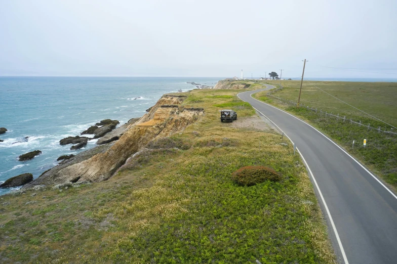 a car driving down a road next to the ocean, bay area, off-roading, gigapixel photo, profile image