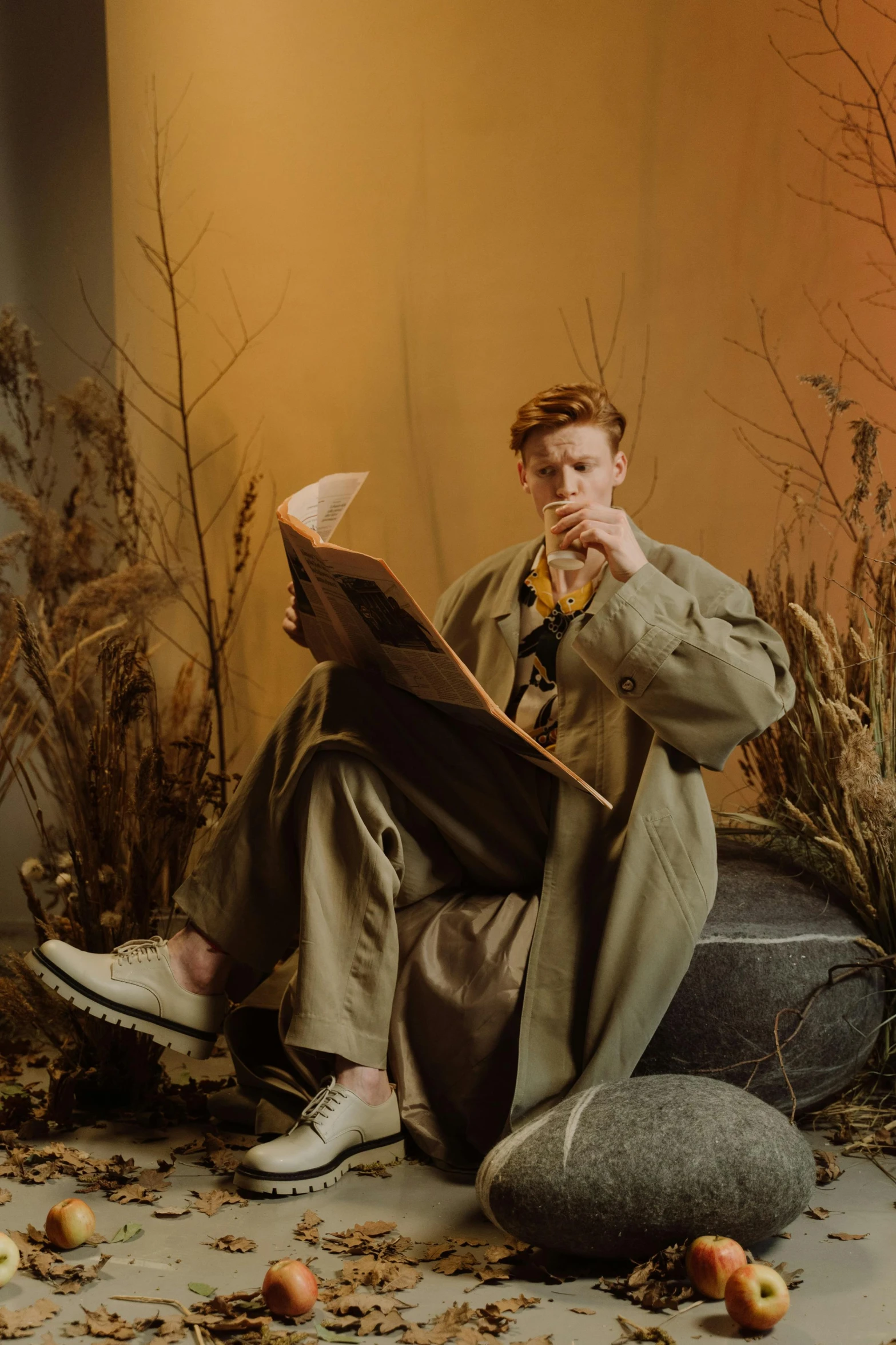 a man sitting on a rock reading a book, an album cover, trending on pexels, mannerism, flowing ginger hair, androgyny, cinematic outfit photo, covered in plants