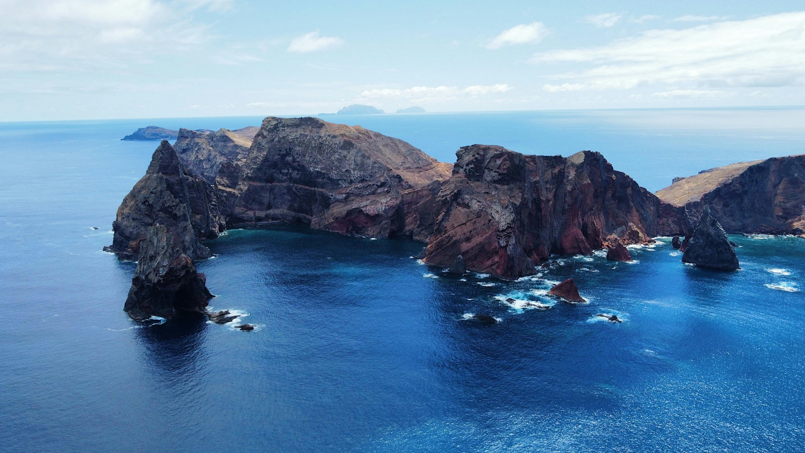 a large rock formation in the middle of a body of water, azores, helicopter view, fan favorite, rock arcs