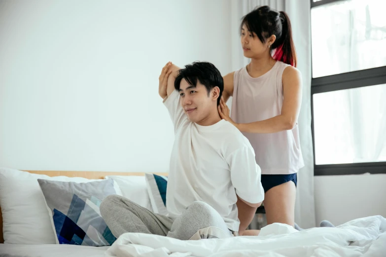 a man sitting on top of a bed next to a woman, a cartoon, pexels contest winner, hurufiyya, waist reaching ponytail, set on singaporean aesthetic, wearing tight shirt, nursing