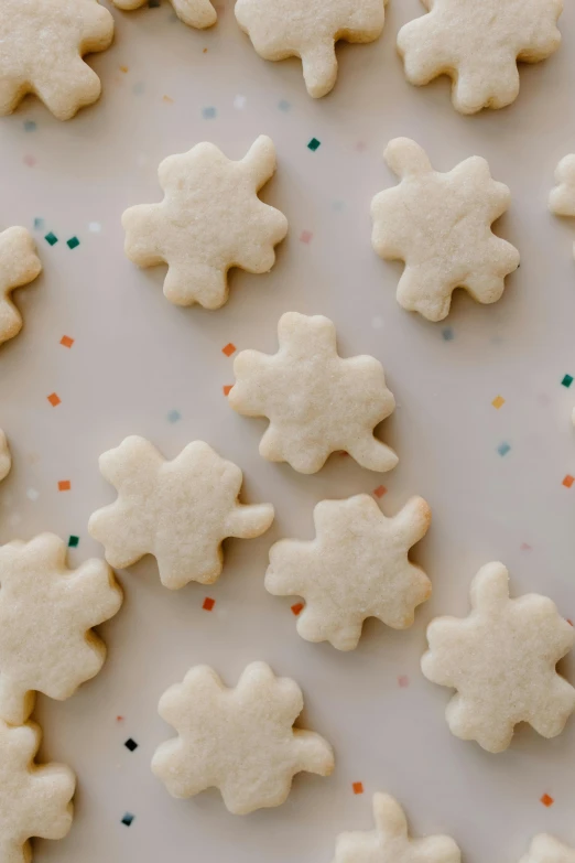 a white plate topped with cookies and sprinkles, a jigsaw puzzle, by Jessie Algie, soft shapes, leafs, vanilla, thumbnail