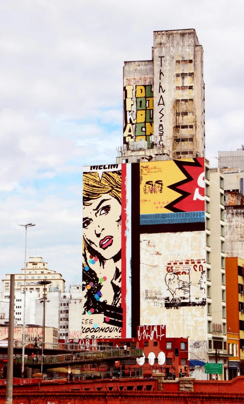 a painting of a woman on the side of a building, inspired by Lichtenstein, trending on pexels, pop art, avenida paulista, panoramic view, old comics in city, billboard image