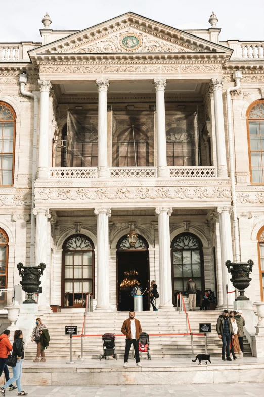 a group of people standing in front of a large building, marble statues, istanbul, mansion, tall entry