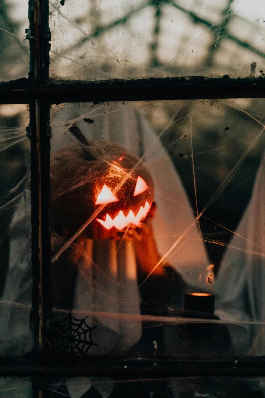 a couple of people that are standing in front of a window, jack - o'- lantern, profile image, lights, cobwebs