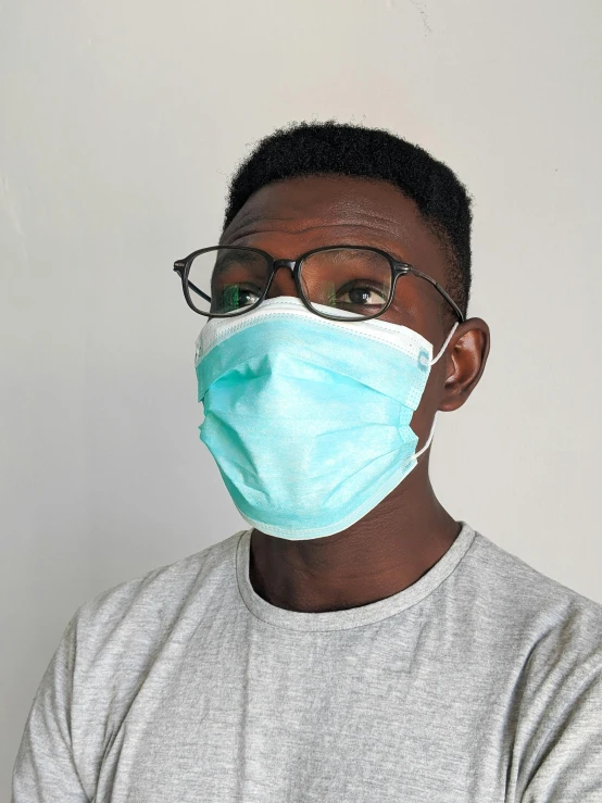 a man wearing a face mask and glasses, by Ryan Pancoast, george pemba, medical image, close up portrait photo, profile image