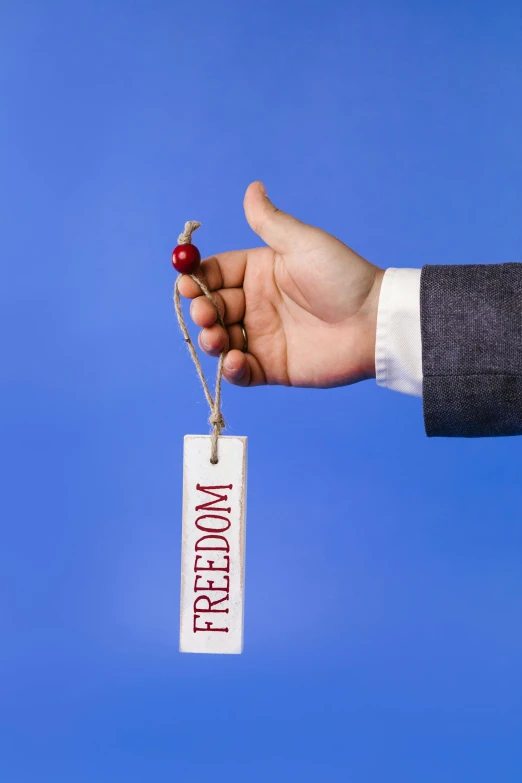 a close up of a person's hand holding a paper tag, pexels, excessivism, freedom, there is one cherry, on clear background, holding a stuff