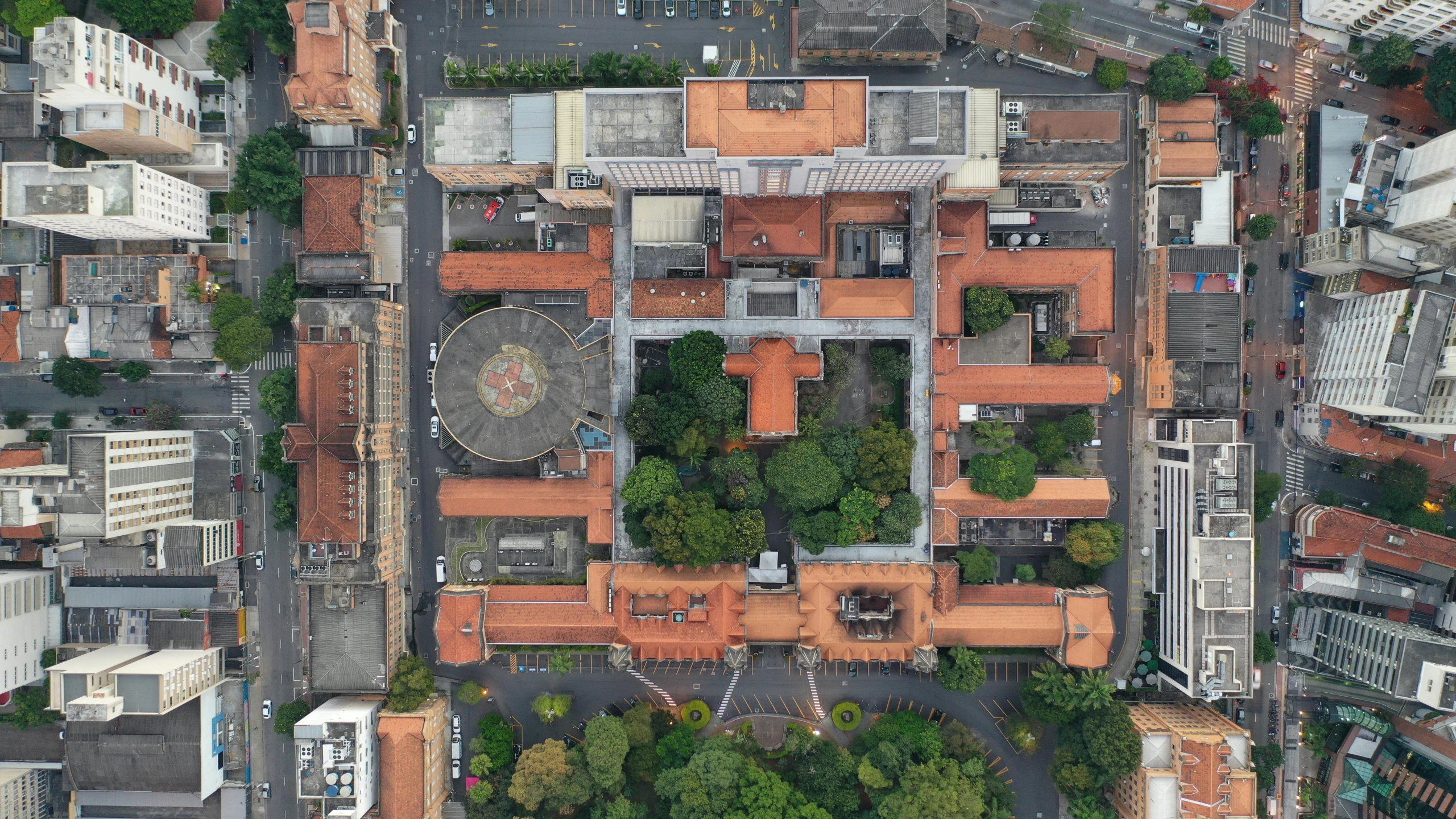 an aerial view of a city with lots of buildings, by Fernando Gerassi, square, exterior photo, brown, colonial