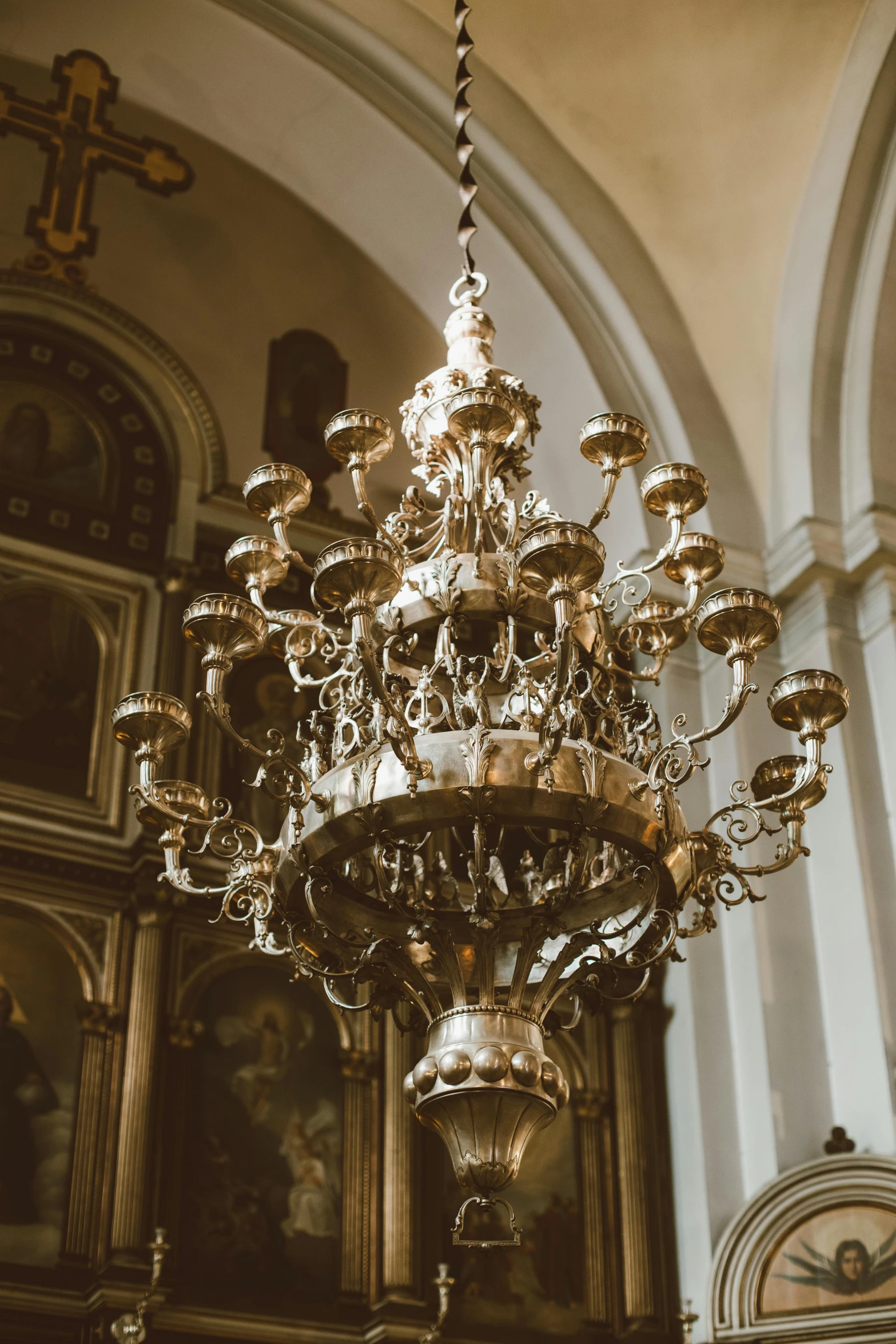 a chandelier hanging from the ceiling of a church, trending on unsplash, baroque, ornate silver armour, on a candle holder, brown, slightly pixelated