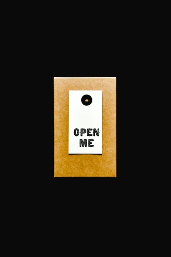 a brown box with a sign that says open me, unsplash, conceptual art, thumbnail, in the style of john baldessari, package cover, icon