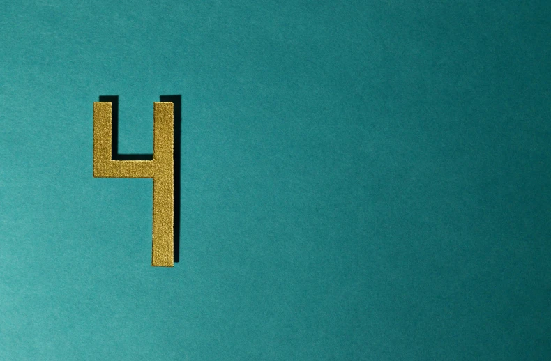 a wooden letter h on a blue background, an album cover, trending on unsplash, hypermodernism, gold and teal color scheme, horrifying :4, f 4, serge lutens