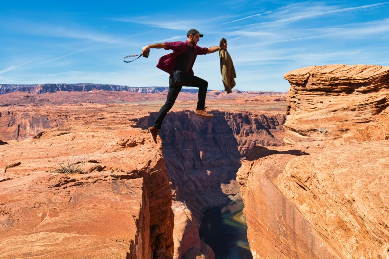 a man standing on top of a cliff holding a skateboard, accidental wild west, hanging veins, lasso tool, antelope canyon