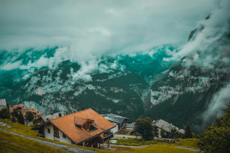 a house sitting on top of a lush green hillside, by Sebastian Spreng, pexels contest winner, icy mountains, avatar image, chalet, tiled roofs