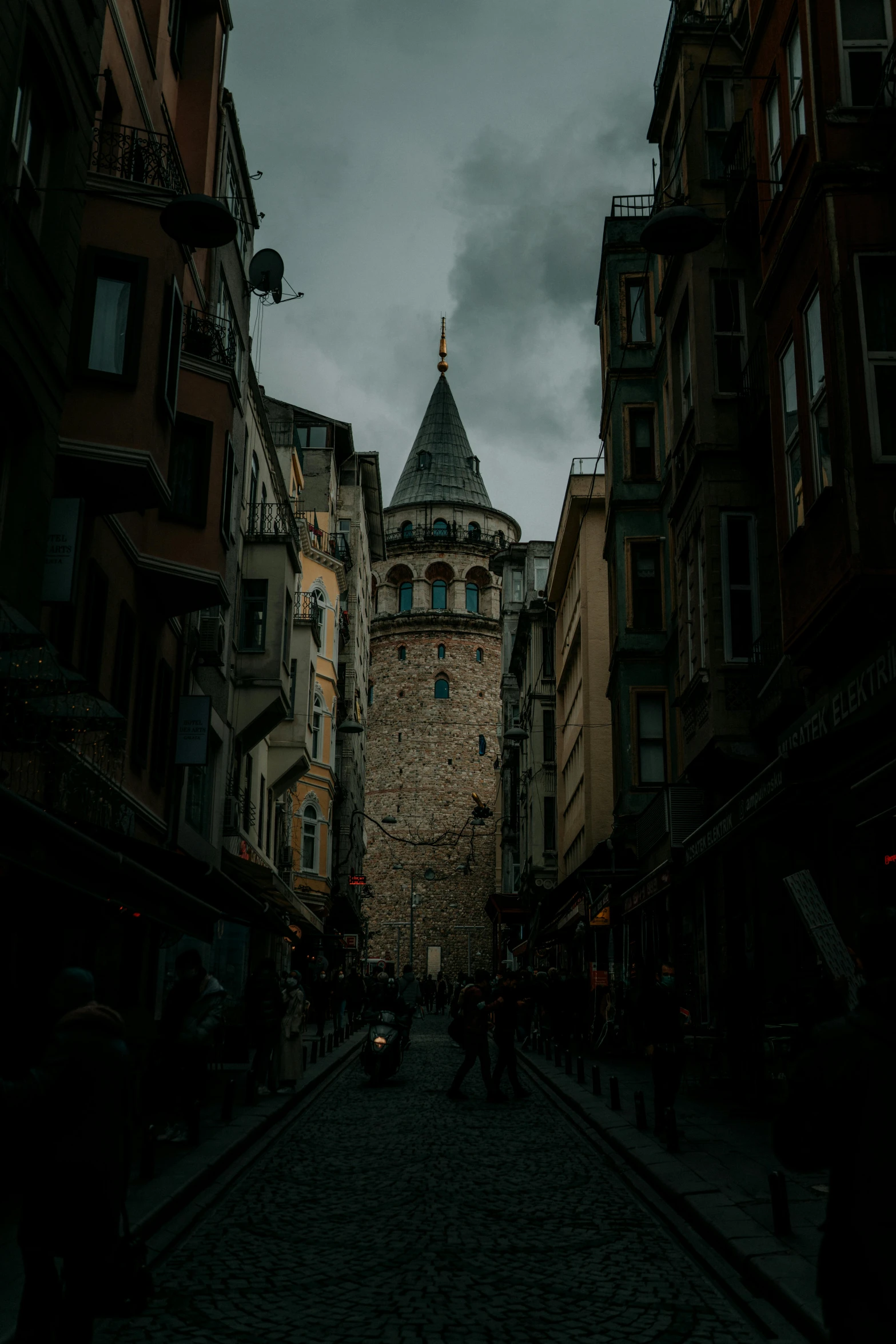 a narrow cobblestone street with a clock tower in the background, an album cover, pexels contest winner, ottoman sultan, ominous photo, turrets, today\'s featured photograph 4k