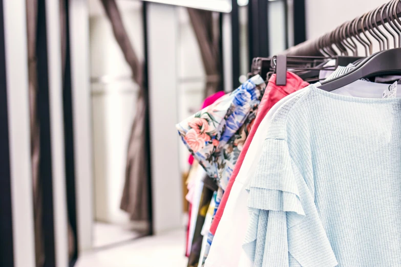 a row of clothes hanging on a rack, a photo, by Nicolette Macnamara, trending on unsplash, floral clothes, zoomed in, presenting wares, 15081959 21121991 01012000 4k