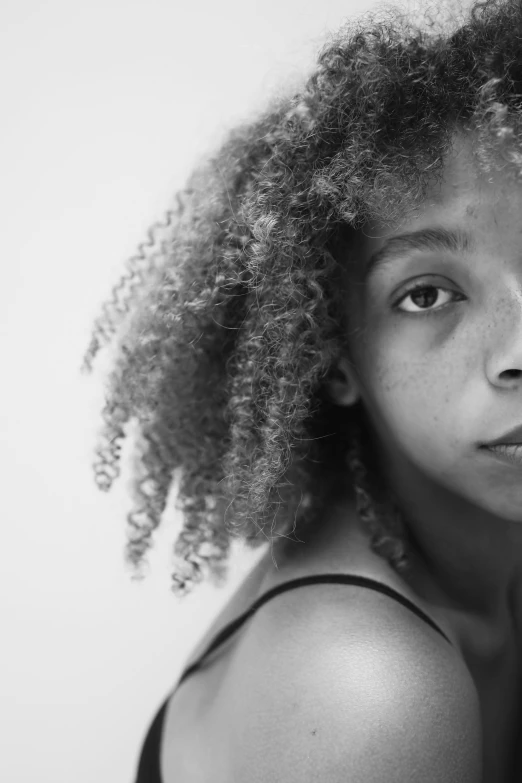 a black and white photo of a woman with curly hair, a black and white photo, inspired by Carrie Mae Weems, pexels contest winner, hyperrealism, portrait of white teenage girl, light-brown skin, portrait of small, 🤤 girl portrait