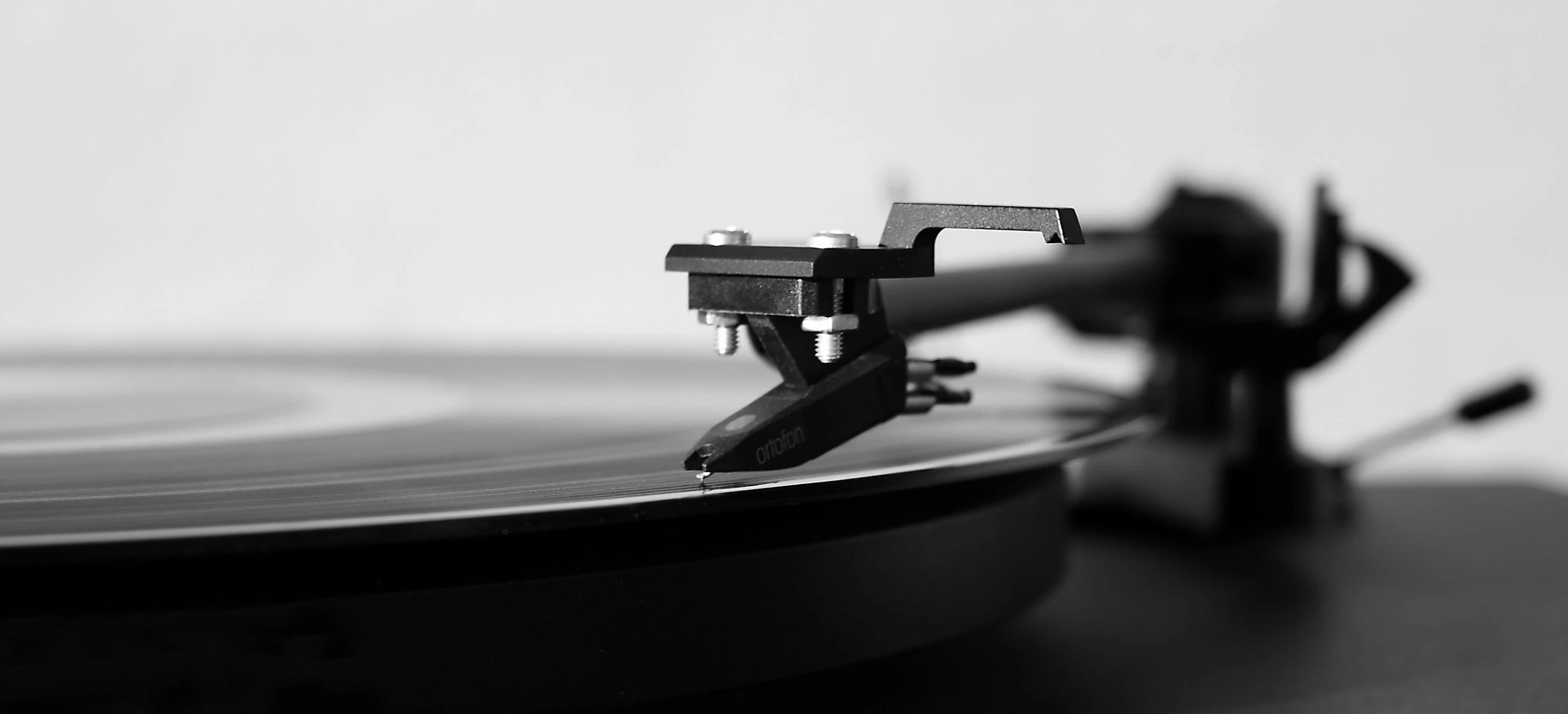 a black and white photo of a turntable, an album cover, unsplash, fine art print, classical, animation, sports photo