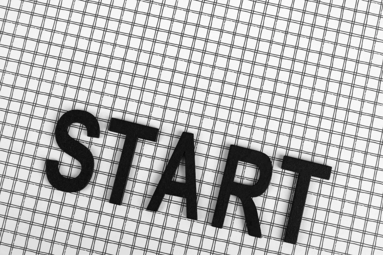 a close up of the word start on a piece of paper, a stock photo, by karolis strautniekas, pexels, grid arrangement, panel of black, in white lettering, figure