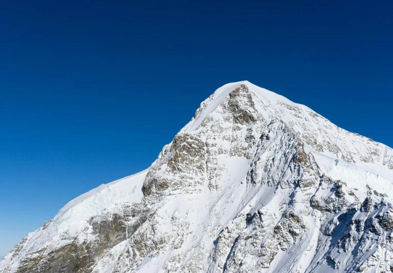 a man standing on top of a snow covered mountain, clear blue skies, geiger, an enormous, biggish nose