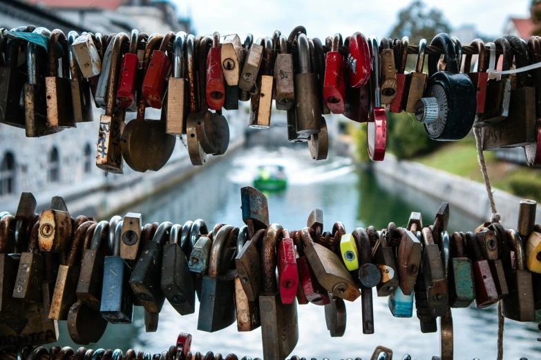 a bunch of padlocks hanging on the side of a river, by Tom Wänerstrand, pexels contest winner, 🦩🪐🐞👩🏻🦳, lots of bridges, thumbnail, slide show