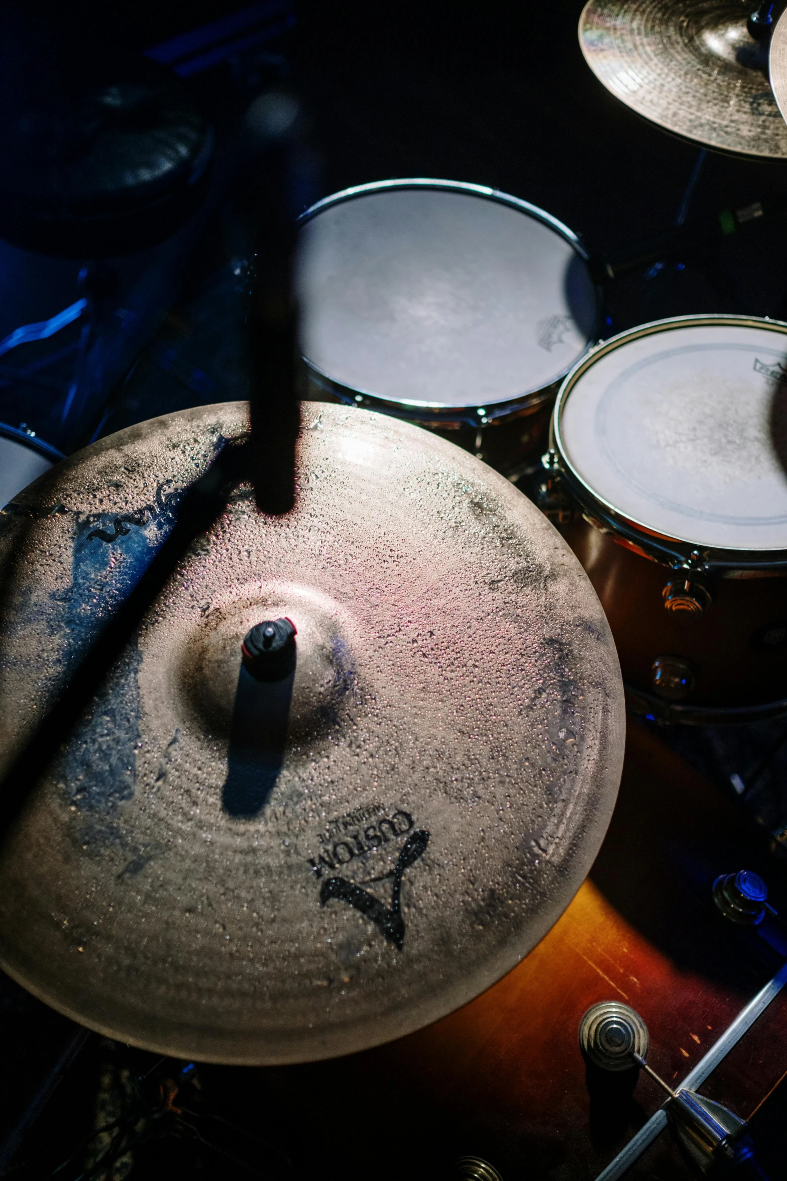 a close up of a drum set in a dark room, an album cover, pexels contest winner, process art, blue, birdseye view, ceramics, proto-metal concert