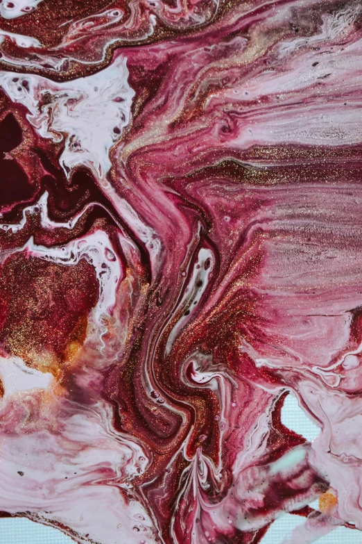 a close up of a piece of art on a table, inspired by Julian Schnabel, trending on pexels, abstract art, maroon, made of liquid, earth, mane