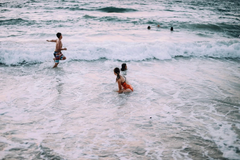 a couple of people that are in the water, pexels contest winner, children playing at the beach, maybe small waves, thumbnail, 1/30