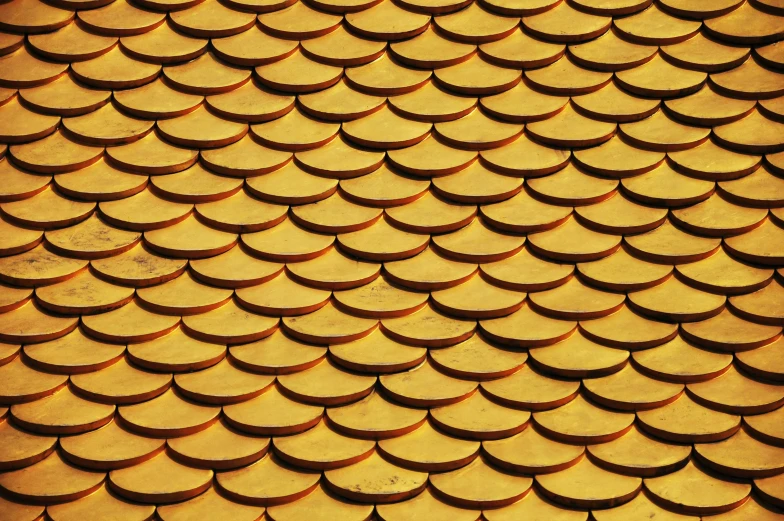 a close up of the roof of a building, a mosaic, pixabay, shades of gold display naturally, tileable, 2 0 0 0's photo, yellow artificial lighting