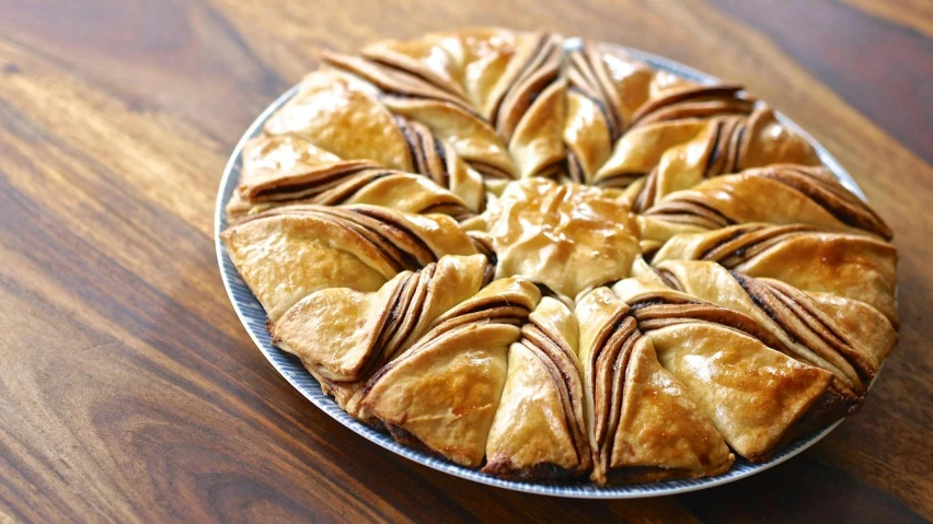 a pie sitting on top of a wooden table, inspired by Slava Raškaj, hurufiyya, intricate wrinkles, pastries, shiny crisp finish, on a wooden tray